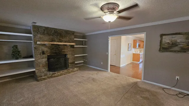a view of a kitchen with a sink a refrigerator cabinets and wooden floor