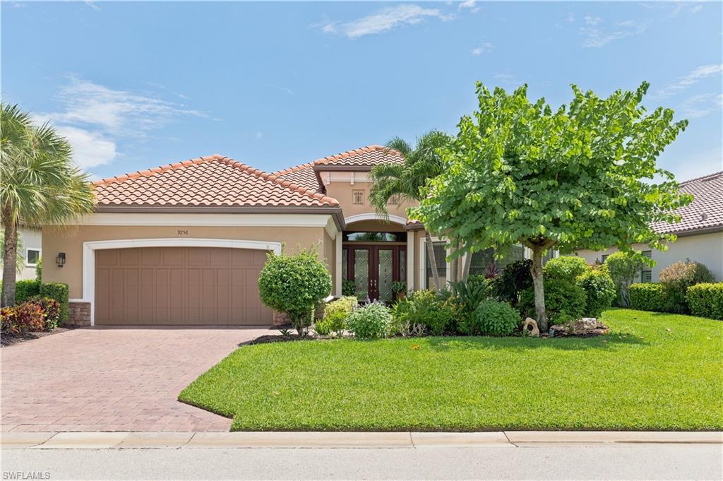 9256 Rialto Lane Naples, FL 34119 - Photo 3 of 43 Inviting entryway featuring double front doors with decorative frosted glass panels and a transom window above