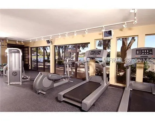 a room with gym equipment and a large window