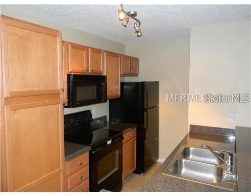 a kitchen with a refrigerator stove and microwave