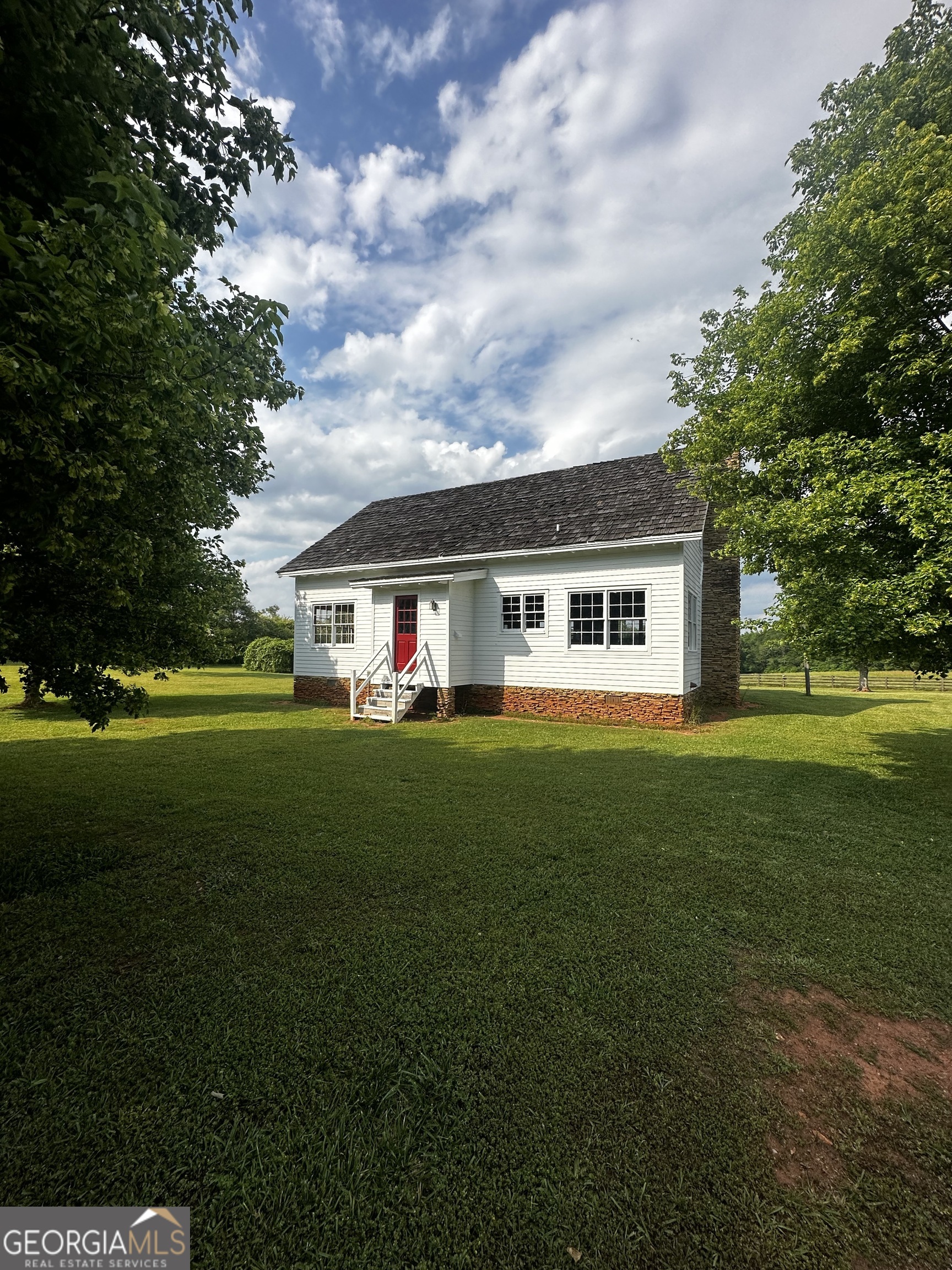a front view of house with yard and green space