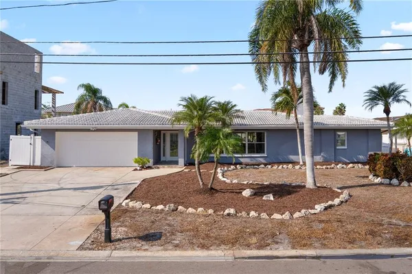 a view of a house with a patio and a yard