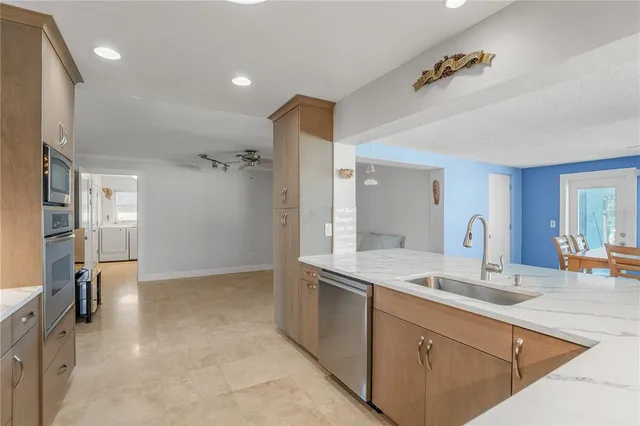a kitchen with a refrigerator and a stove top oven