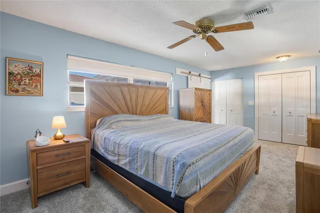 a bedroom with a bed and a cabinets