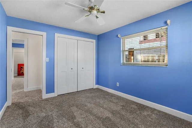 a view of a kitchen with fridge and workspace