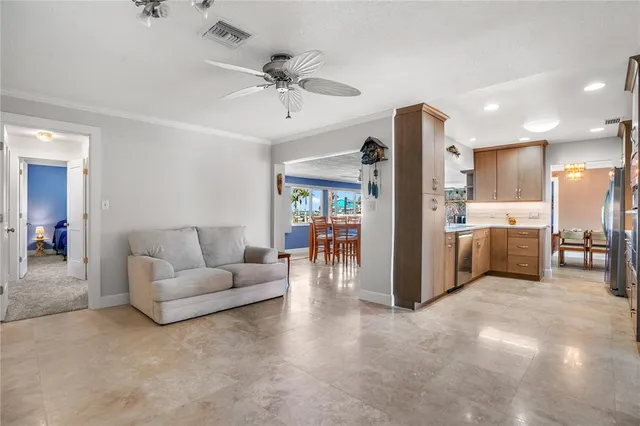 a large kitchen with stainless steel appliances kitchen island granite countertop a stove a sink and a refrigerator