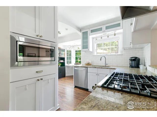 a kitchen with a stove and white cabinets