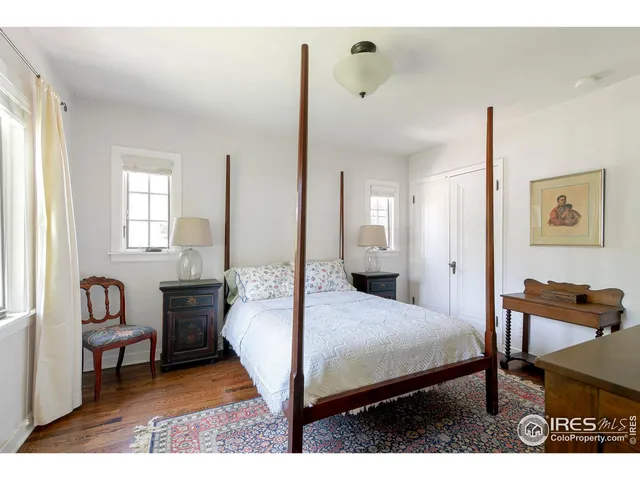 a bedroom with a bed a table and chair