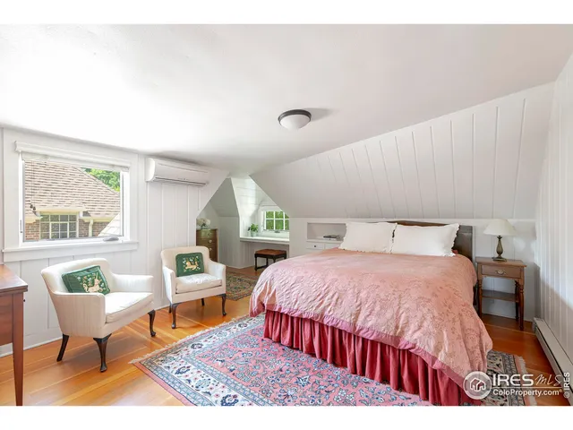 a bedroom with a bed a table and chair