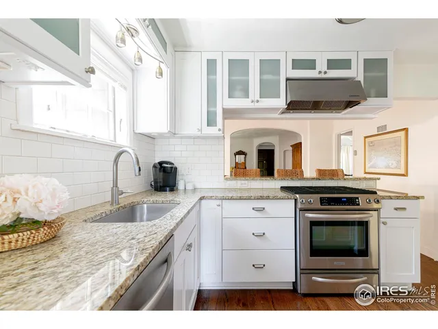 a kitchen with cabinets appliances and a sink