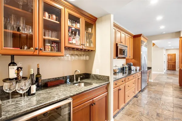 a kitchen with stainless steel appliances granite countertop a sink stove and cabinets
