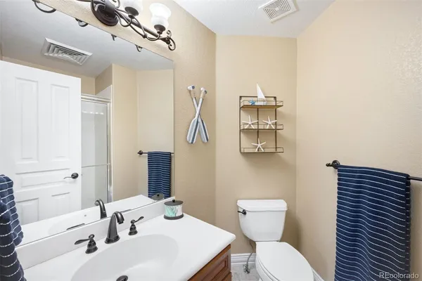 a bathroom with a sink a toilet and mirror