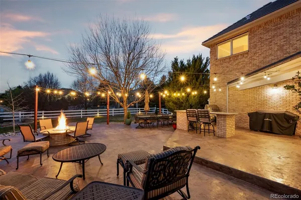 a view of a patio with swimming pool and sitting area