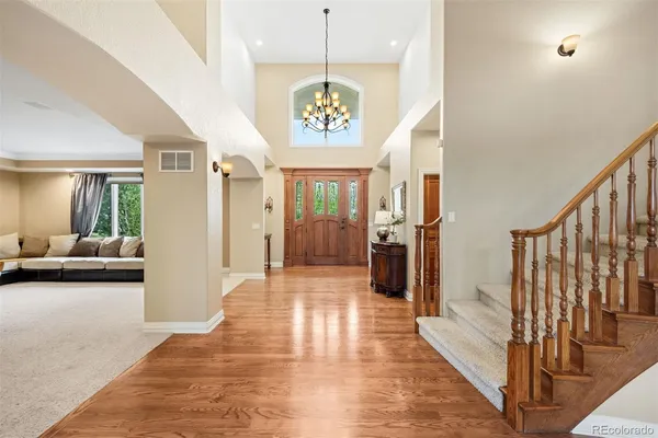 a view of a hallway with wooden floor windows and a living room