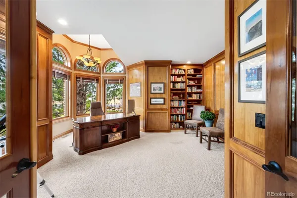 a large room with a large window and furniture