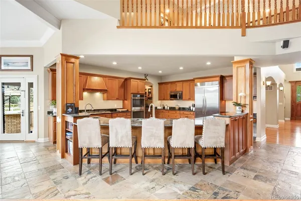a large kitchen with a table and chairs