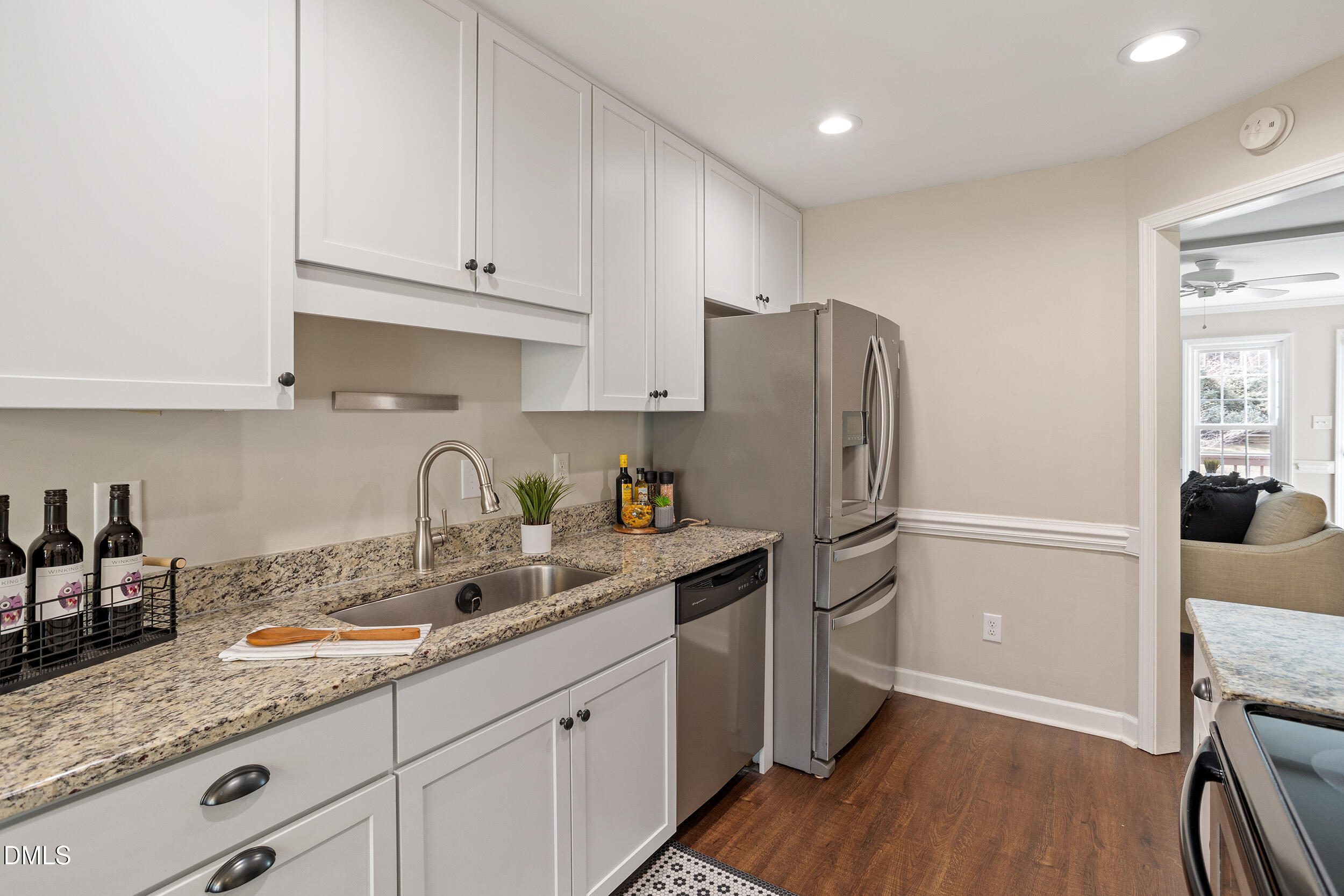 4619 Hershey Court Raleigh, NC 27613 - Photo 11 of 43 a kitchen with granite countertop a refrigerator and a sink