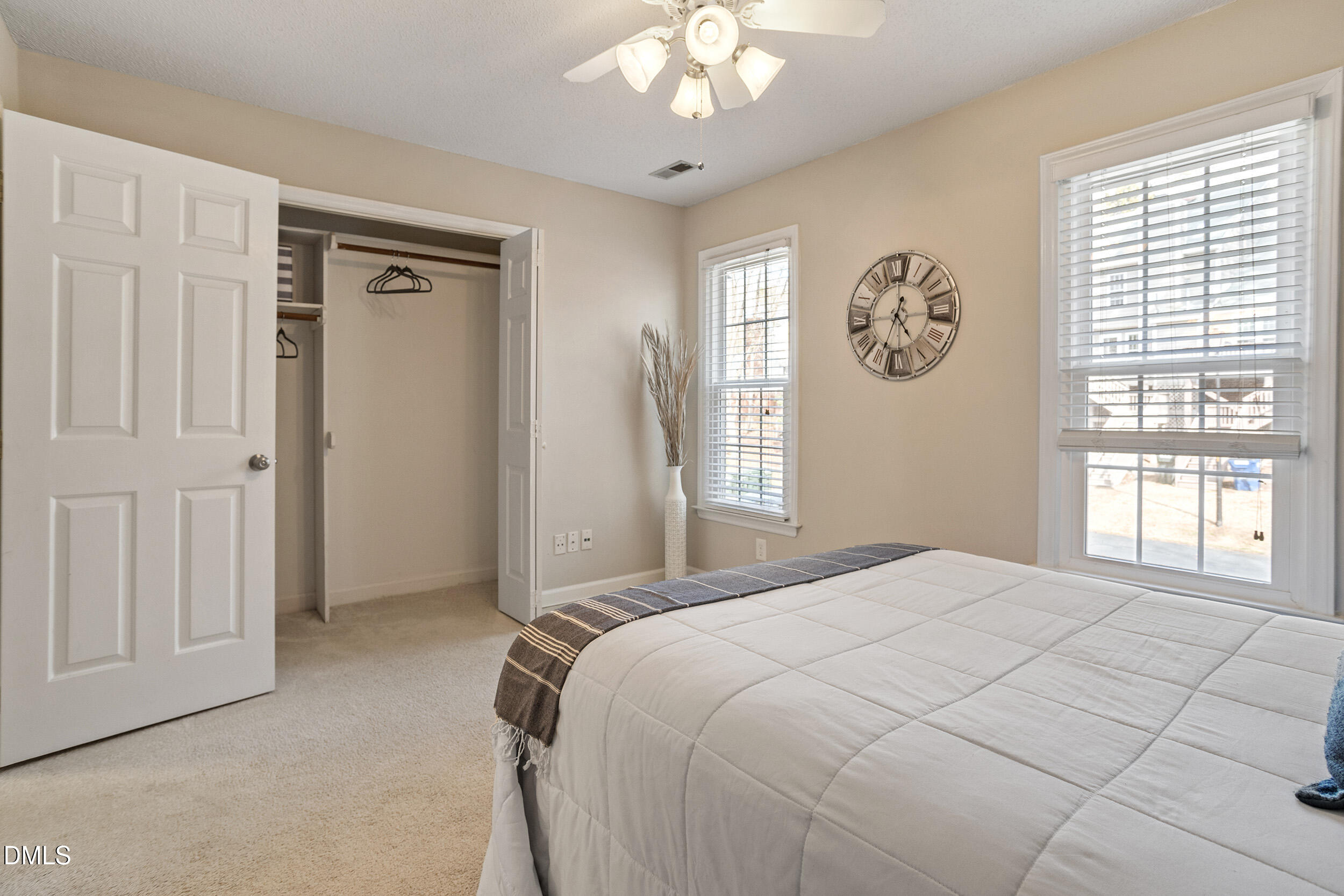 4619 Hershey Court Raleigh, NC 27613 - Photo 20 of 43 a spacious bedroom with a bed and a window
