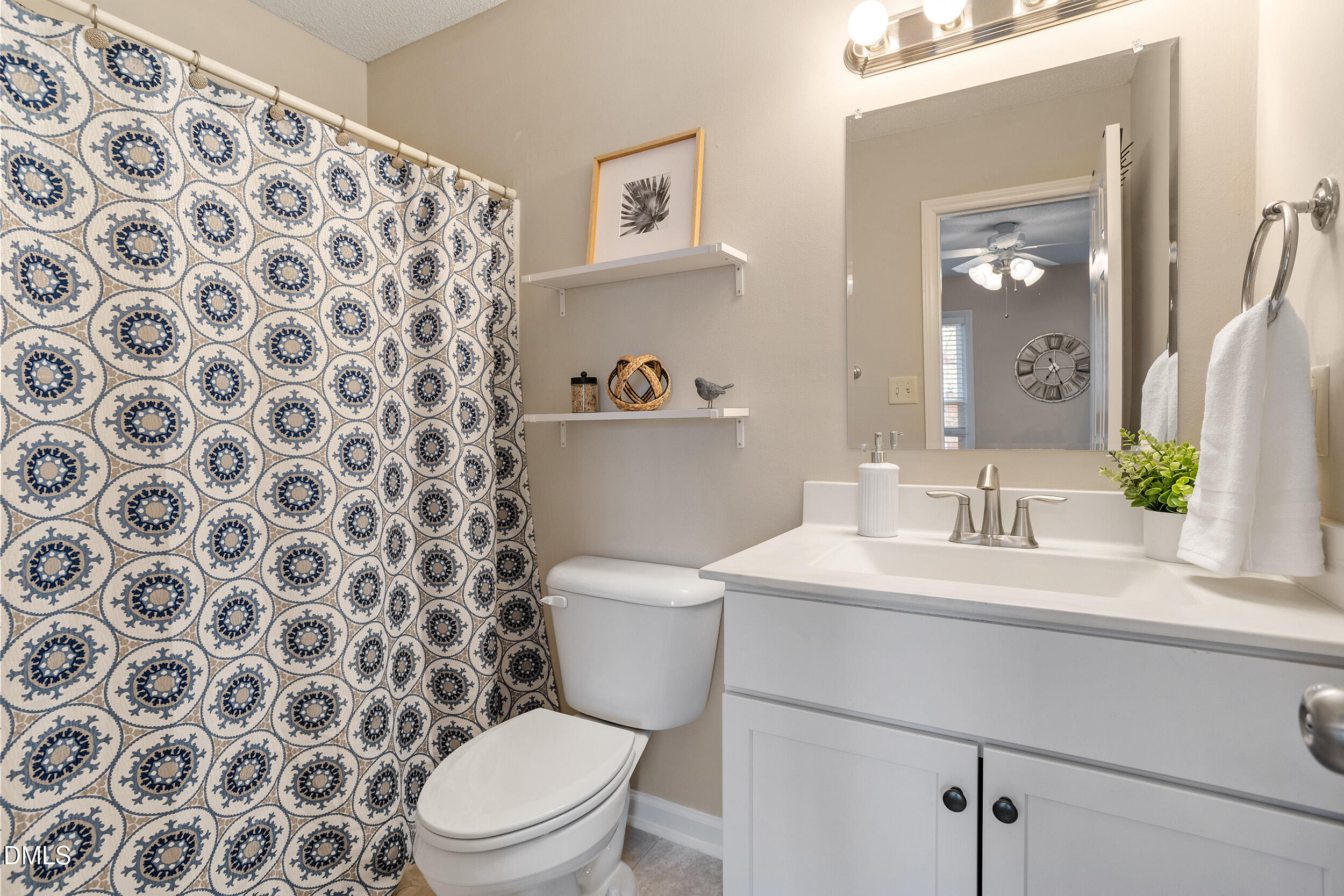 4619 Hershey Court Raleigh, NC 27613 - Photo 21 of 43 a bathroom with a toilet sink and mirror