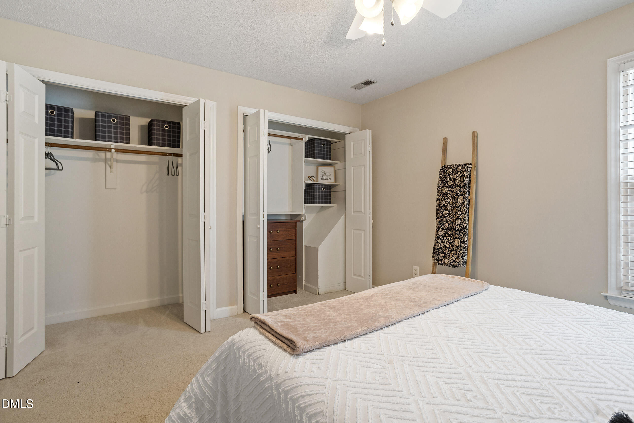 4619 Hershey Court Raleigh, NC 27613 - Photo 22 of 43 a bedroom with a large bed and a chandelier