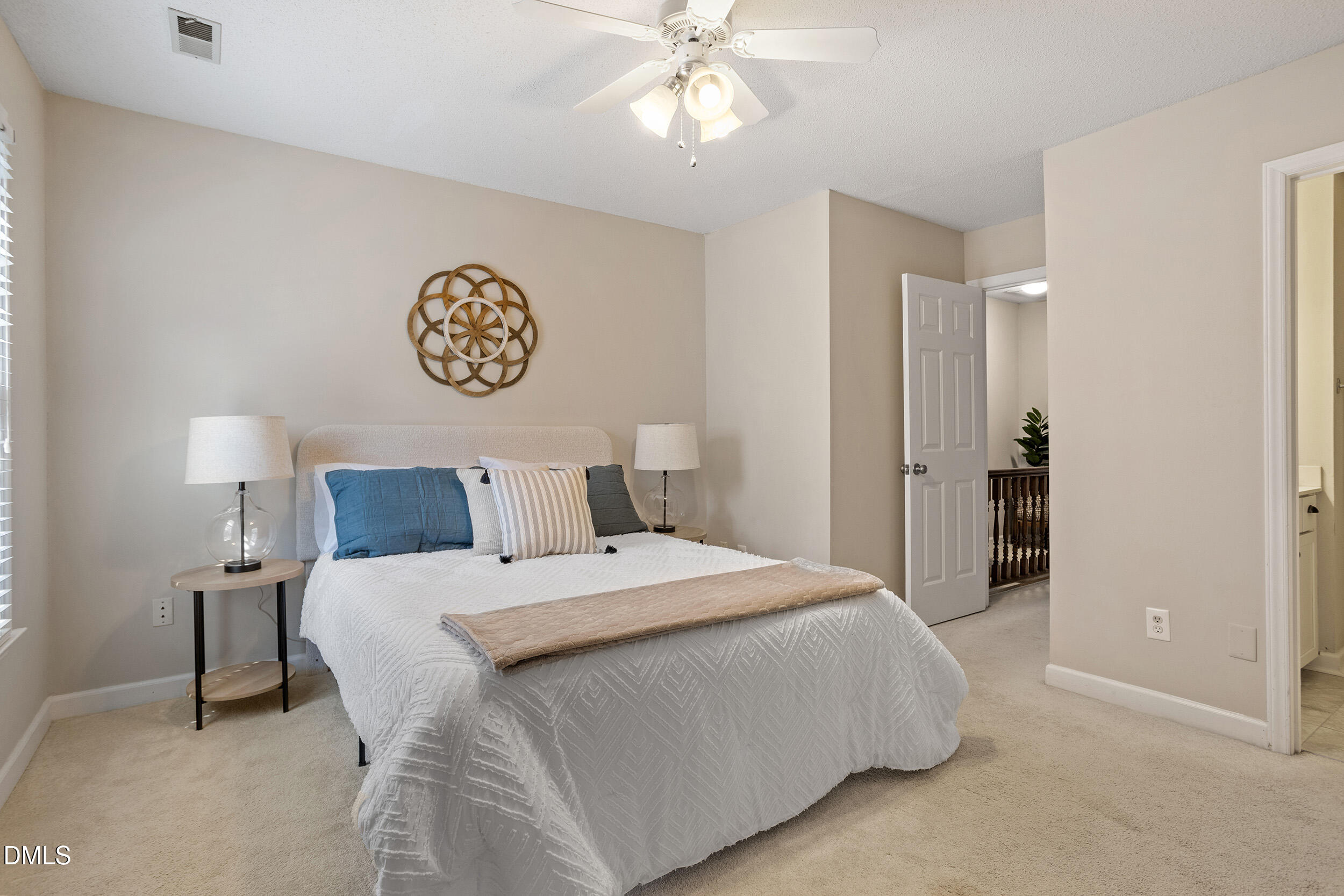 4619 Hershey Court Raleigh, NC 27613 - Photo 24 of 43 a bedroom with a bed and a chandelier