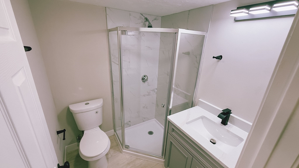 26 Maple Street Spencer, MA 01562 - Photo 13 of 27 a white toilet sitting next to a bathroom sink