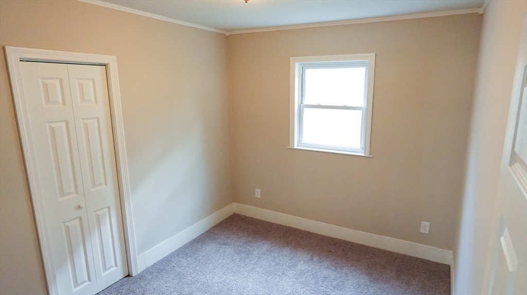 26 Maple Street Spencer, MA 01562 - Photo 14 of 27 an empty room with a window
