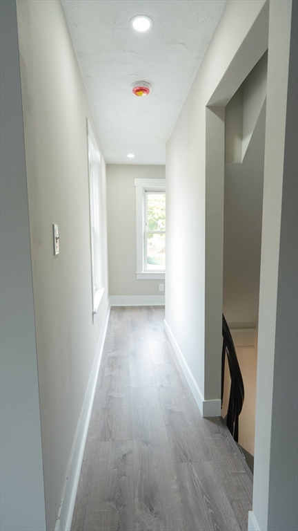 26 Maple Street Spencer, MA 01562 - Photo 23 of 27 a view of hallway with window and wooden floor
