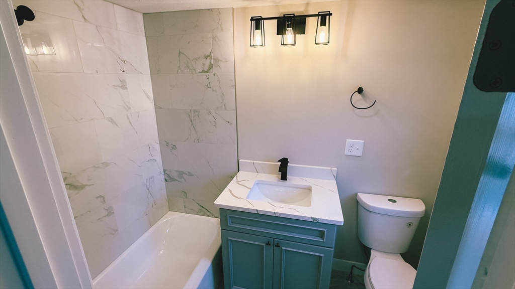 26 Maple Street Spencer, MA 01562 - Photo 24 of 27 a bathroom with a sink toilet and shower