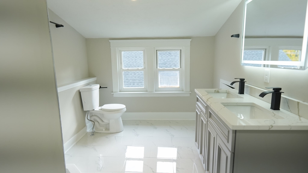 26 Maple Street Spencer, MA 01562 - Photo 26 of 27 a bathroom with a sink toilet and window