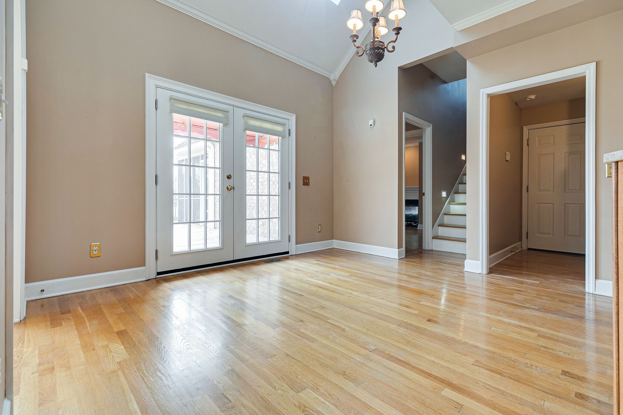Undisclosed Address Franklin, TN 37064 - Photo 13 of 67 a view of a room with wooden floor and chandelier