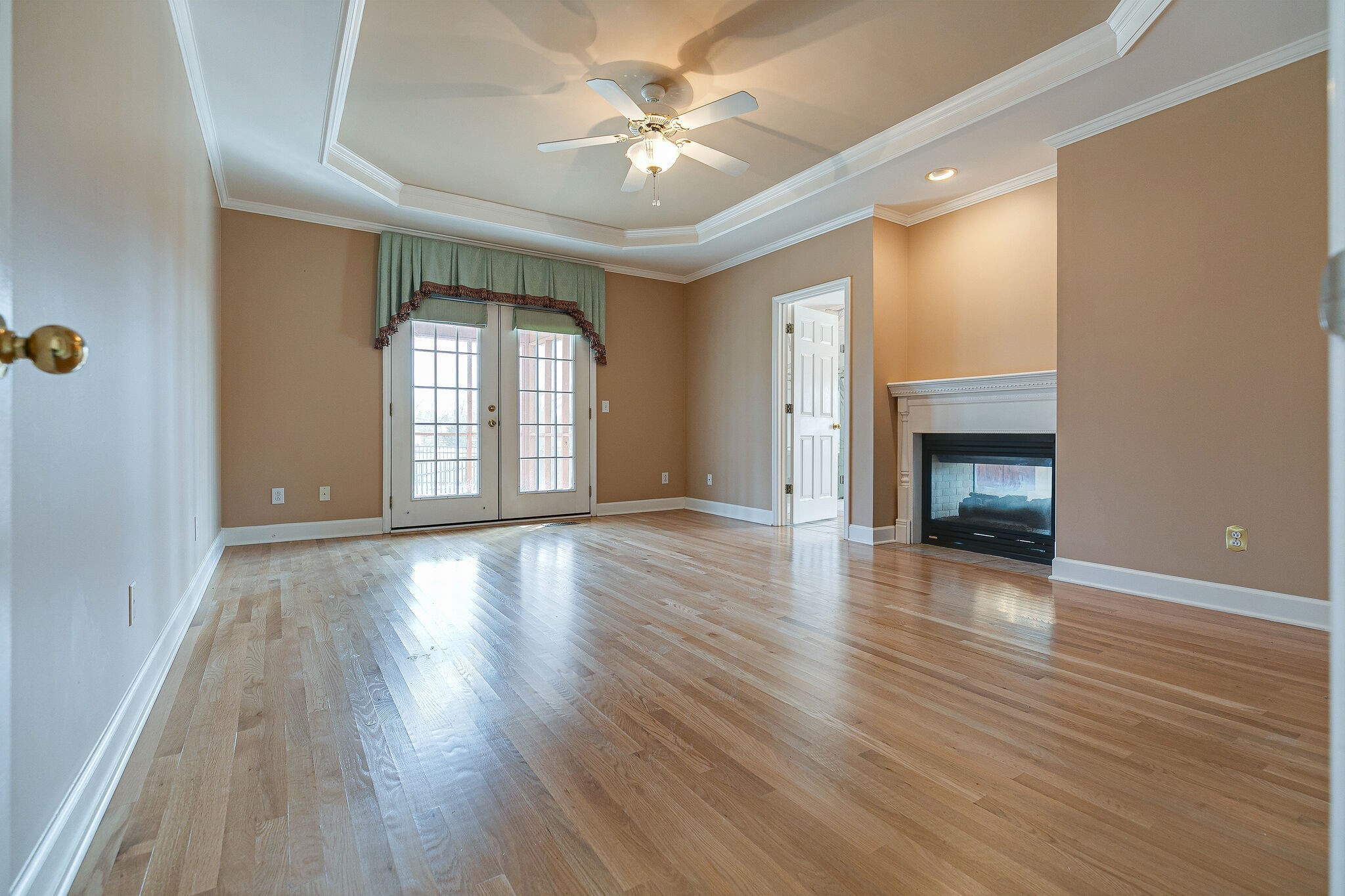 Undisclosed Address Franklin, TN 37064 - Photo 18 of 67 an empty room with wooden floor fireplace and windows