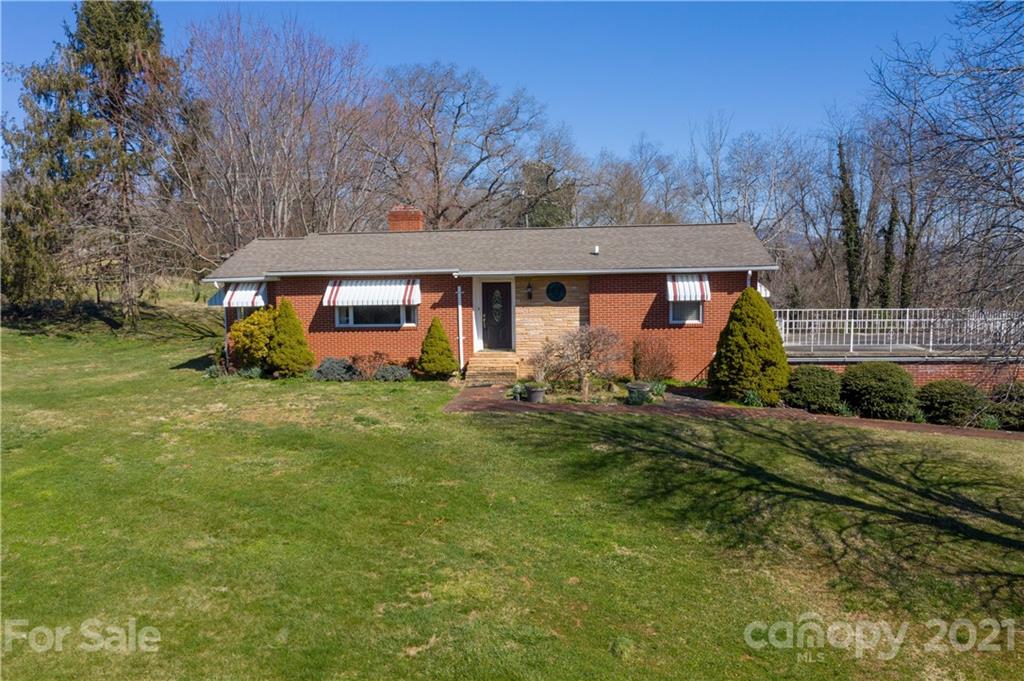 85 Walnut Ford Road Clyde, NC 28721 - Photo 1 of 24 a front view of house with yard and green space