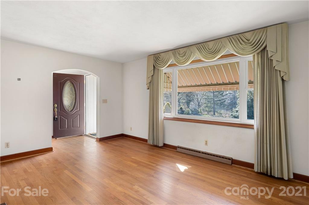 85 Walnut Ford Road Clyde, NC 28721 - Photo 11 of 24 a view of an empty room with a window and a mirror