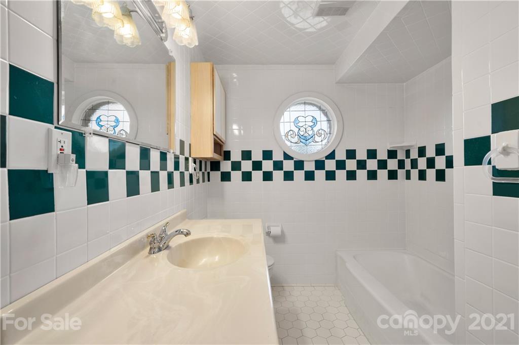 85 Walnut Ford Road Clyde, NC 28721 - Photo 18 of 24 a bathroom with a bathtub and a shower