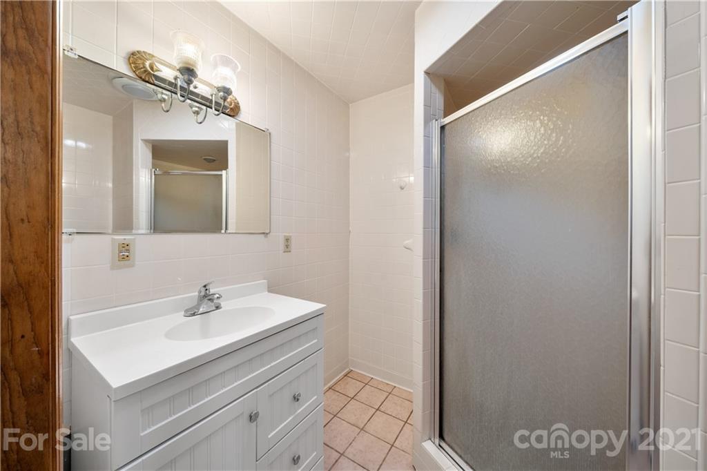 85 Walnut Ford Road Clyde, NC 28721 - Photo 21 of 24 a bathroom with a sink mirror and vanity