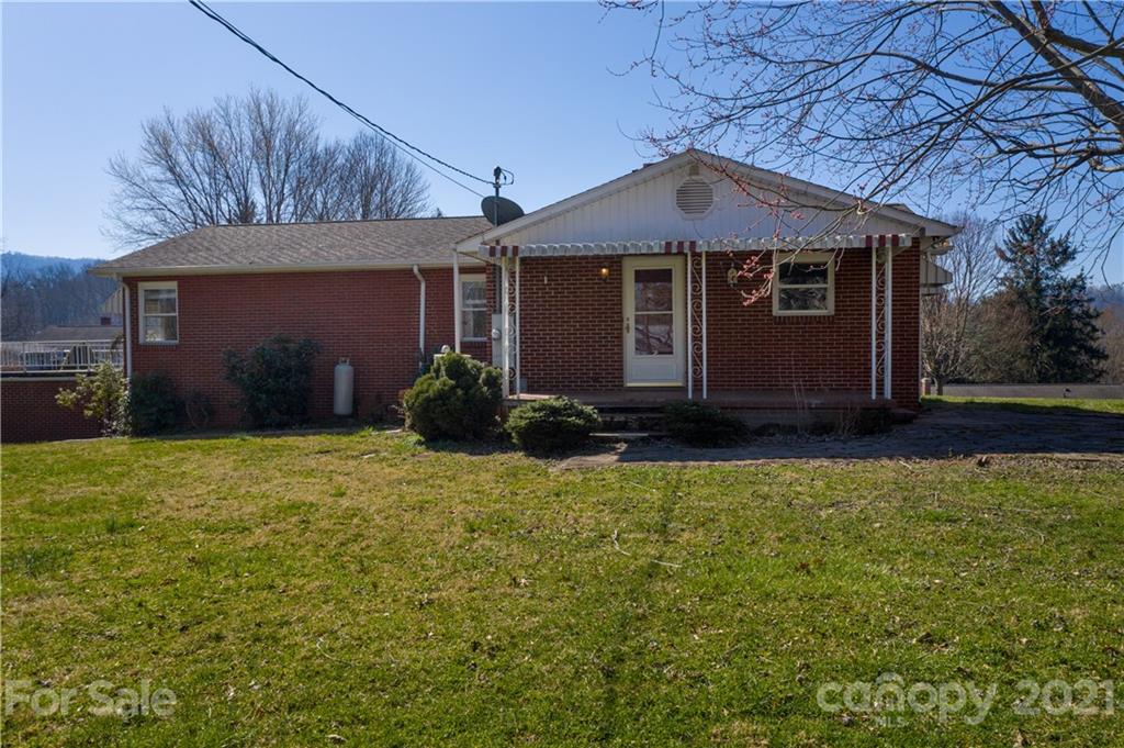 85 Walnut Ford Road Clyde, NC 28721 - Photo 5 of 24 a front view of a house with a yard