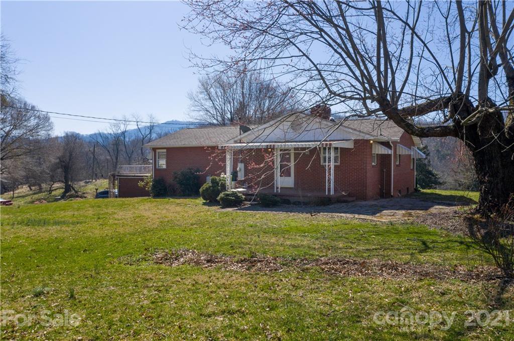 85 Walnut Ford Road Clyde, NC 28721 - Photo 6 of 24 a view of a house with a yard and tree