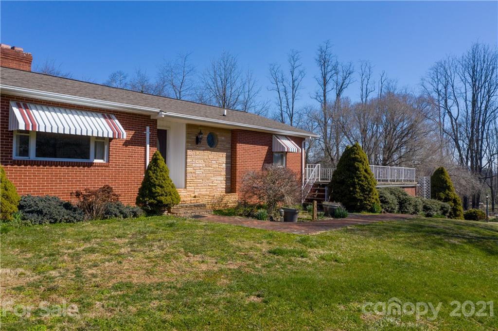 85 Walnut Ford Road Clyde, NC 28721 - Photo 7 of 24 a front view of a house with a yard