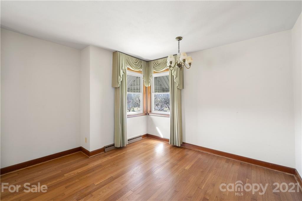 85 Walnut Ford Road Clyde, NC 28721 - Photo 10 of 24 an empty room with wooden floor and windows