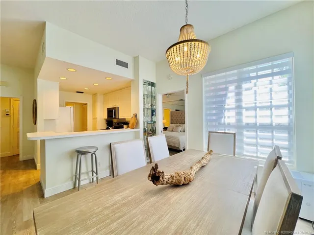 a living room filled with furniture and a floor to ceiling window