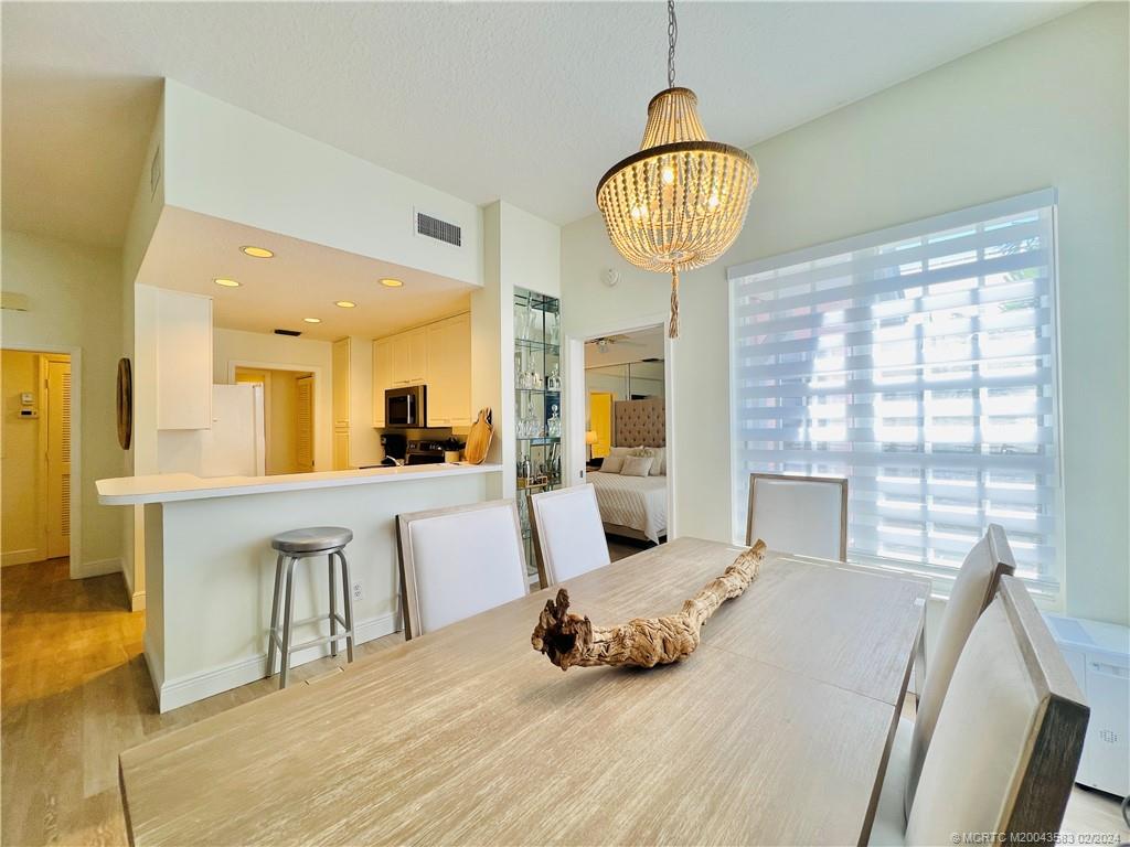 411 Northeast Plantation Road, Unit 526 Stuart, FL 34996 - Photo 17 of 76 a large bedroom with a bed and a large mirror