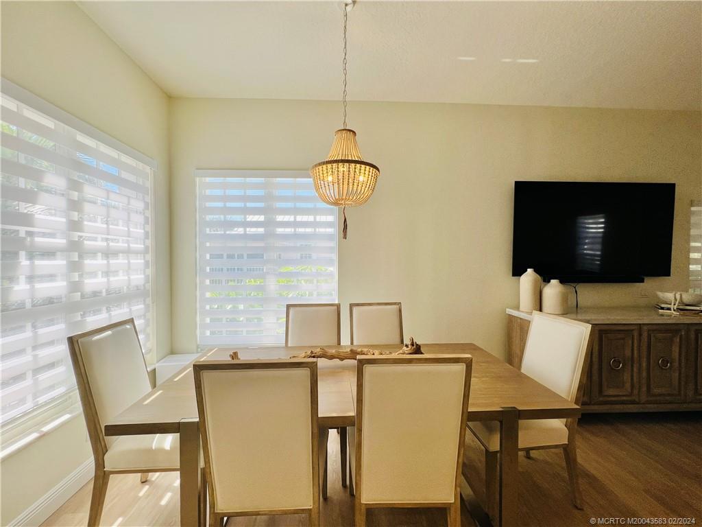 411 Northeast Plantation Road, Unit 526 Stuart, FL 34996 - Photo 18 of 76 a living room with a flat screen tv and a large window