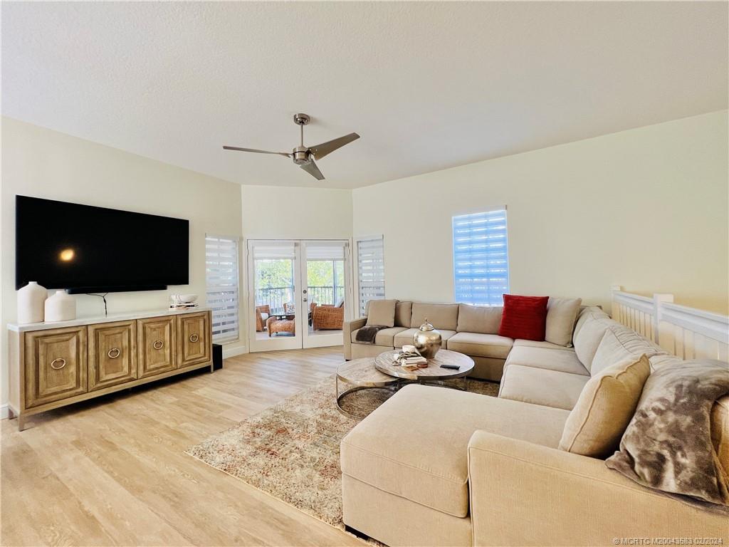 411 Northeast Plantation Road, Unit 526 Stuart, FL 34996 - Photo 21 of 76 a living room with furniture and a flat screen tv