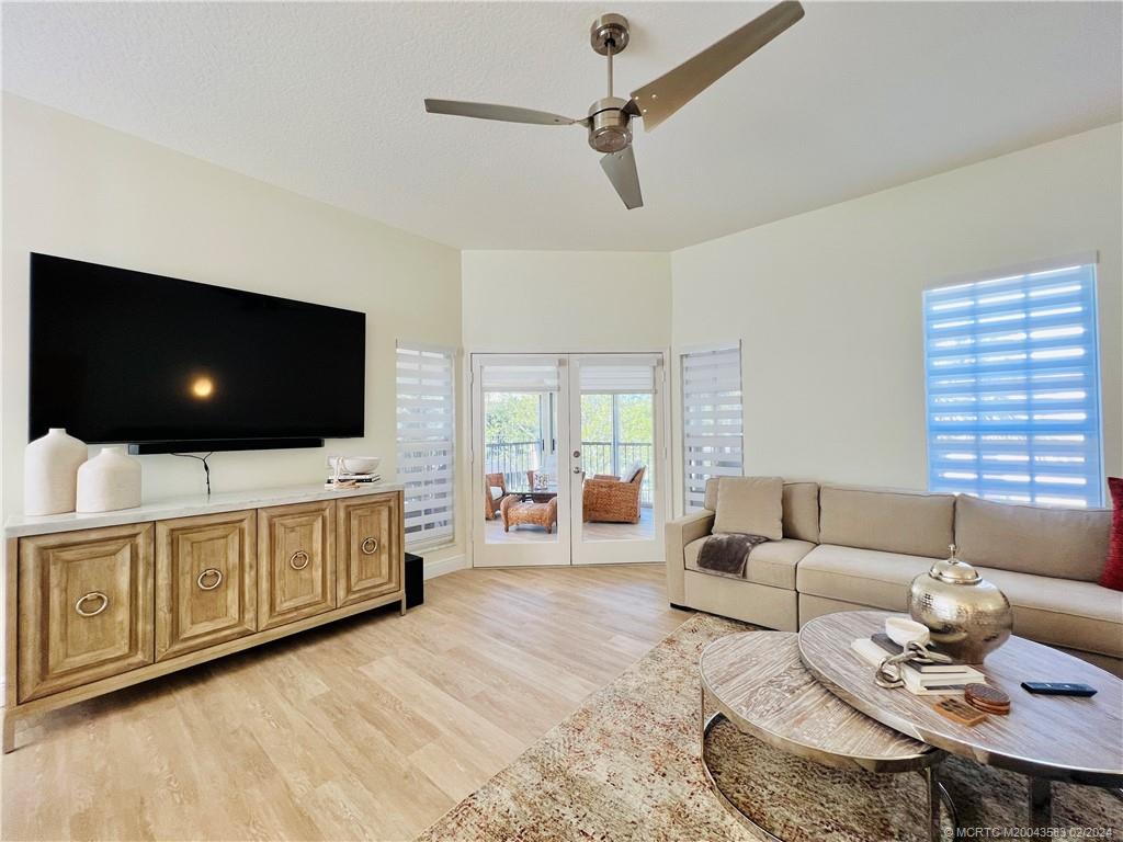 411 Northeast Plantation Road, Unit 526 Stuart, FL 34996 - Photo 25 of 76 a living room with furniture and a flat screen tv