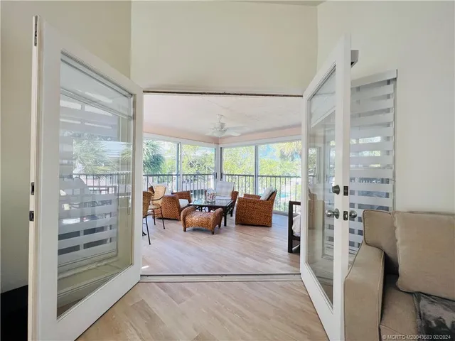 a bedroom with furniture and a large window