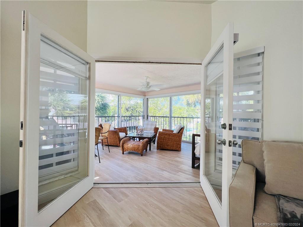 411 Northeast Plantation Road, Unit 526 Stuart, FL 34996 - Photo 26 of 76 a living room filled with furniture and a floor to ceiling window