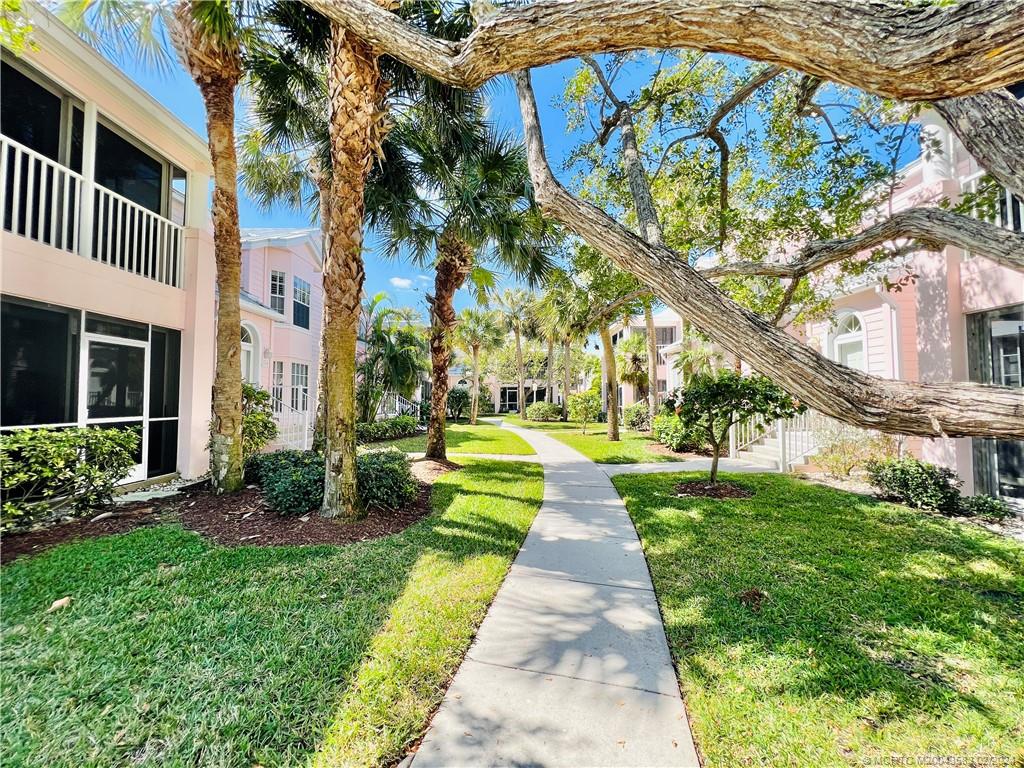 411 Northeast Plantation Road, Unit 526 Stuart, FL 34996 - Photo 3 of 76 a front view of a house with a yard