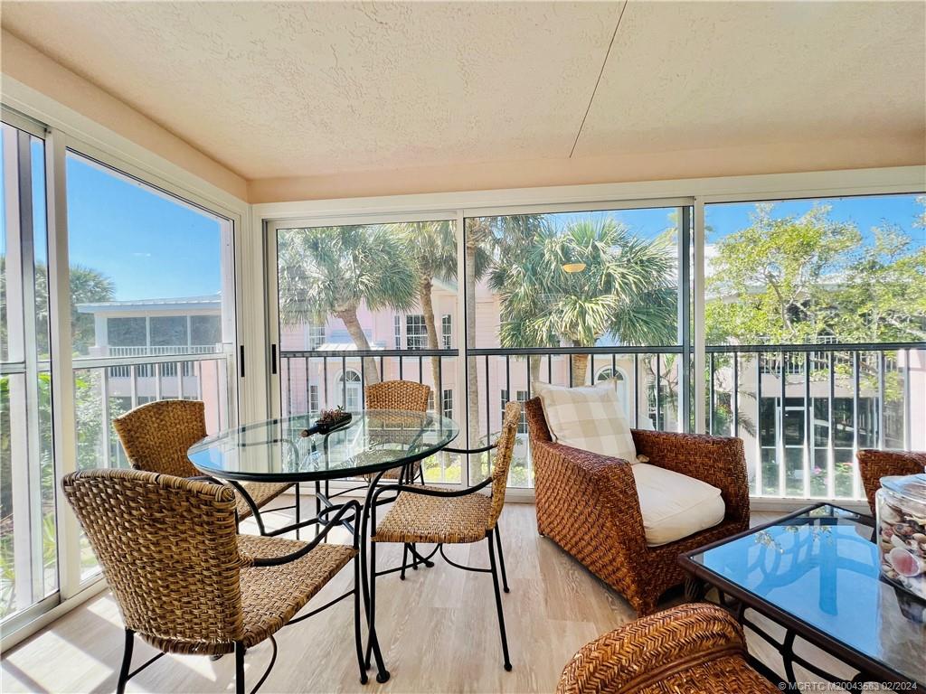 411 Northeast Plantation Road, Unit 526 Stuart, FL 34996 - Photo 31 of 76 a dining room with furniture and wooden floor