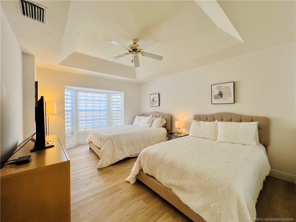 411 Northeast Plantation Road, Unit 526 Stuart, FL 34996 - Photo 38 of 76 a bed room with two beds and a flat screen tv